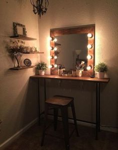 a vanity with lights on it and a stool in front of the mirror that is lit up