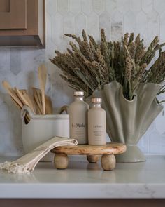 some bottles and spoons are sitting on a counter