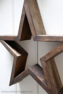 a wooden star hanging from the side of a door with two open sides on it