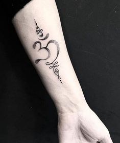 a woman's arm with a tattoo that says love and two hearts on it