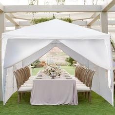 a table set up under a white tent