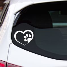 a car with a heart and paw prints on it's side window sticker