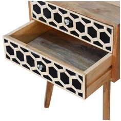 a wooden table with two drawers on one side and an animal print design on the other