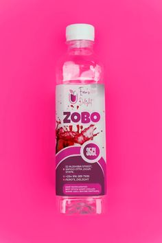 a bottle of liquid on a pink background with the word zobo in it