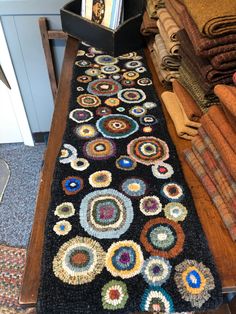 a long black rug with various colored circles on it