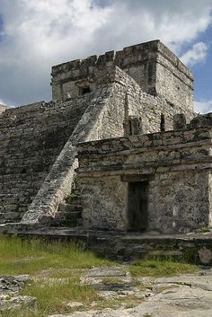 an ancient building with steps leading up to it