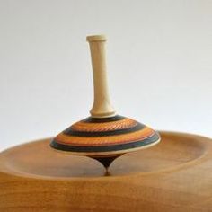 a wooden stand with a vase on it