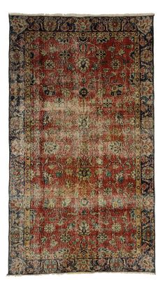 an antique rug with red and blue colors