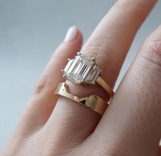 a close up of a person's hand with a ring on it