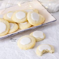 cookies with white icing are on a plate