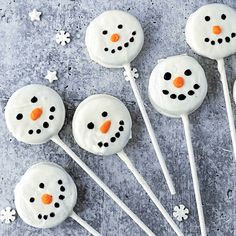 frosted marshmallows are arranged in the shape of a snowman on a stick