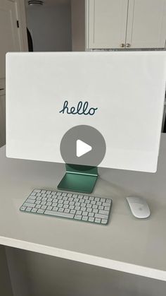 a desktop computer sitting on top of a white desk next to a mouse and keyboard