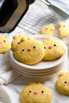 some cookies with faces on them sitting on a plate