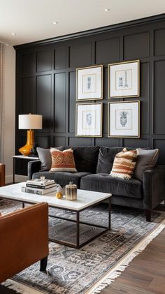 a living room filled with furniture and pictures hanging on the wall above it's coffee table