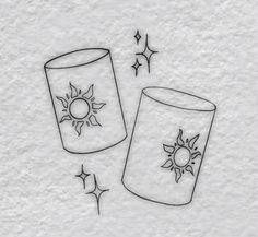 a drawing of two cups with the sun and stars on them