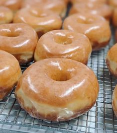 there are many glazed donuts on the cooling rack