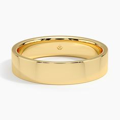 a yellow gold wedding ring on a white background