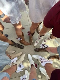 several people standing in a circle with their shoes on