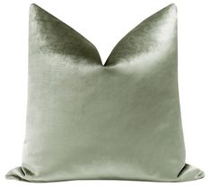 a light green pillow on a white background