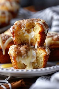 cinnamon sugar muffins stacked on top of each other with icing drizzled over them