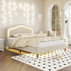 a bedroom with white furniture and lights on the wall above the bed is decorated in pastel colors