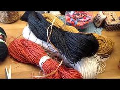 several skeins of yarn on a table with scissors and other crafting supplies