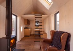 a living room filled with furniture and a fire place in front of a wooden stove