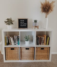 a book shelf with baskets and books on it