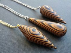 three wooden pendants are hanging from chains