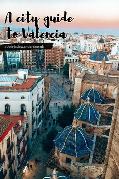 an aerial view of the city with text overlay that reads a city guide to the valencaa