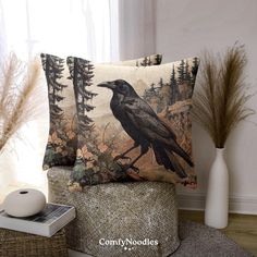 a pillow with a black bird on it sitting next to a basket and some plants