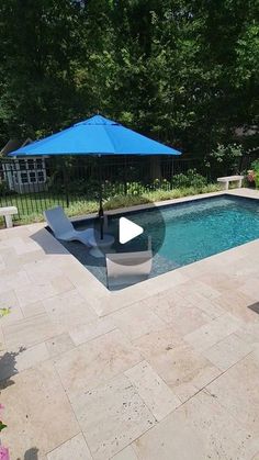 a pool with an umbrella and chairs around it