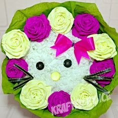 a hello kitty cake decorated with pink and white roses