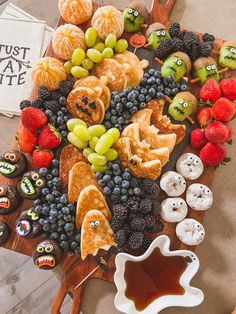 an assortment of fruit and pastries on a cutting board with the words just say bite