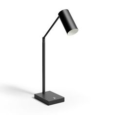 a black lamp on a white background with the light turned off to show its dim lighting