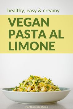 a white bowl filled with pasta and vegetables on top of a table next to a sign that says vegan pasta limoone