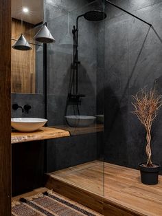 a bathroom with a wooden floor and black walls