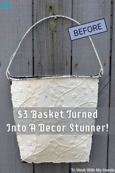 a white basket hanging on the side of a wooden fence with a sign that says, 3