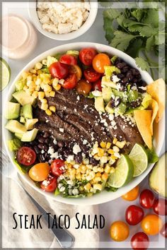 steak taco salad with avocado, tomatoes, corn and cilantro