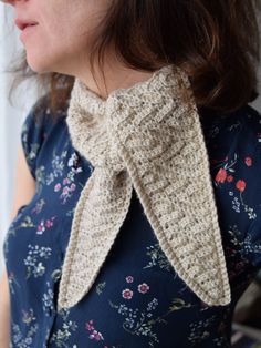 a close up of a woman wearing a neck tie with flowers on the top and bottom