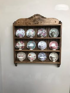 a wooden shelf with many plates on it