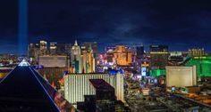 the city lights shine brightly at night in this view from top of a skyscraper building