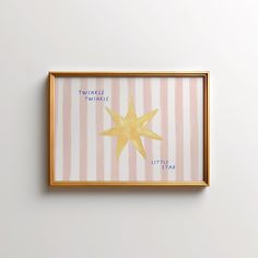 a gold framed star on a pink and white striped wall