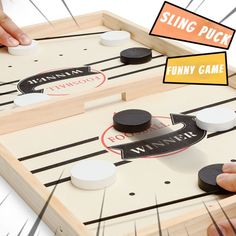 two people playing a game of air hockey with the words swing puck and funny game