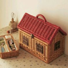 a small wicker basket sitting on top of a table next to a magazine holder