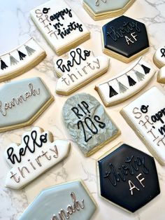 decorated cookies are arranged on a marble table