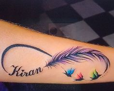 a woman's arm with a tattoo on it that reads, iris and two birds