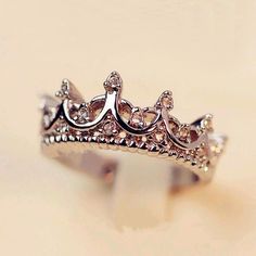 a silver ring with a crown on it