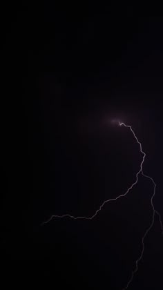 lightning strikes in the dark night sky with bright lightening from it's left side