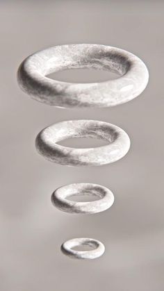 three rings floating on top of water in the air